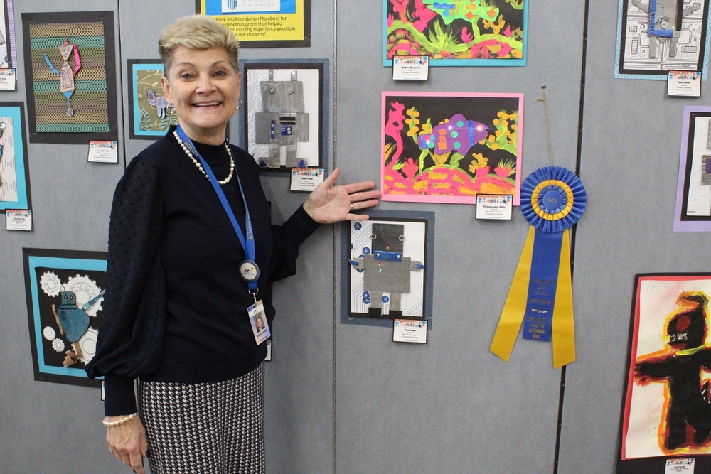 Superintendent Anstadt smiling with piece of art