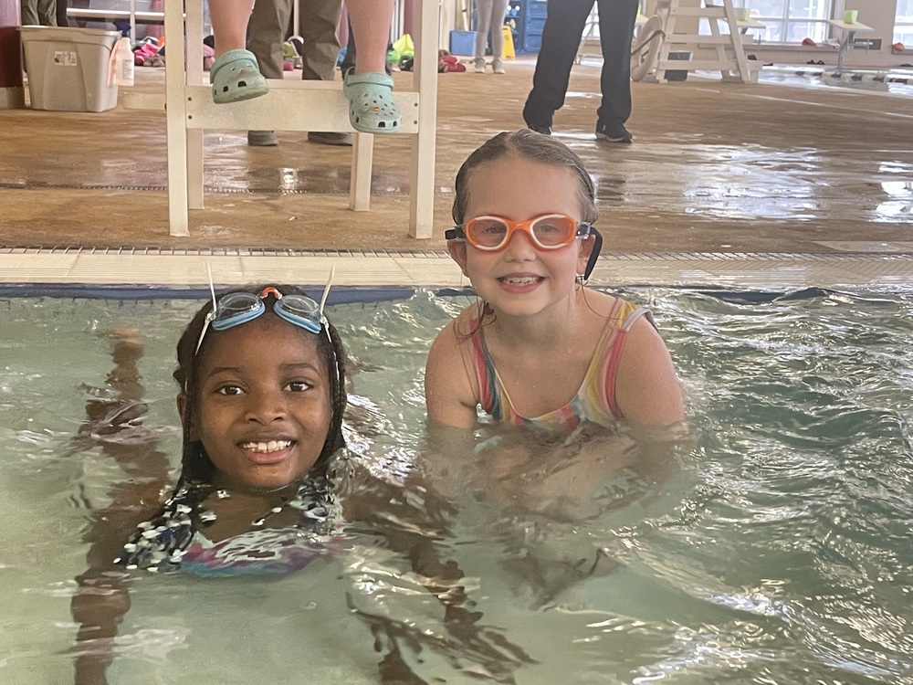 Two children swimming and smiling