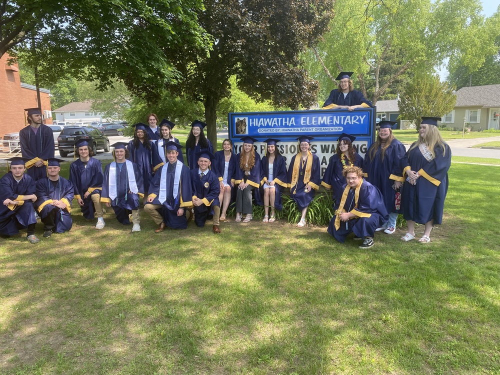 Grads in front of sign