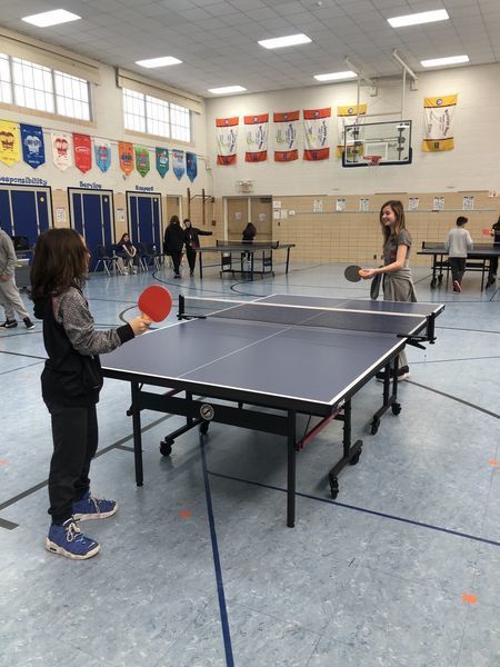 Two children play ping pong
